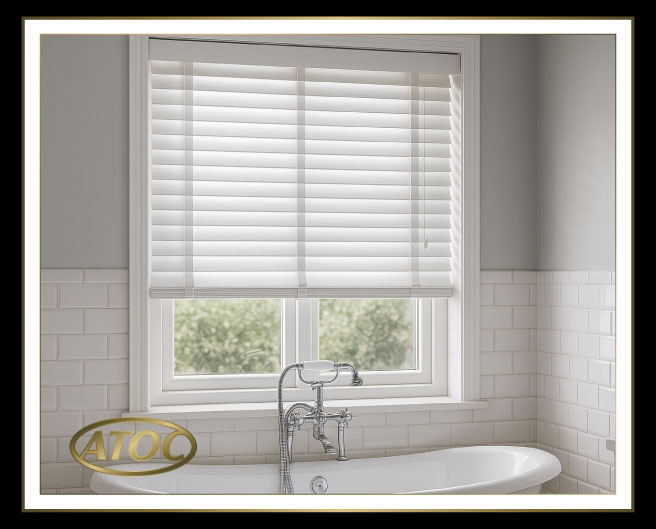 Close-up of faux wood venetian blinds showing solid PVC slats, wood-grain colours and decorative woven tapes