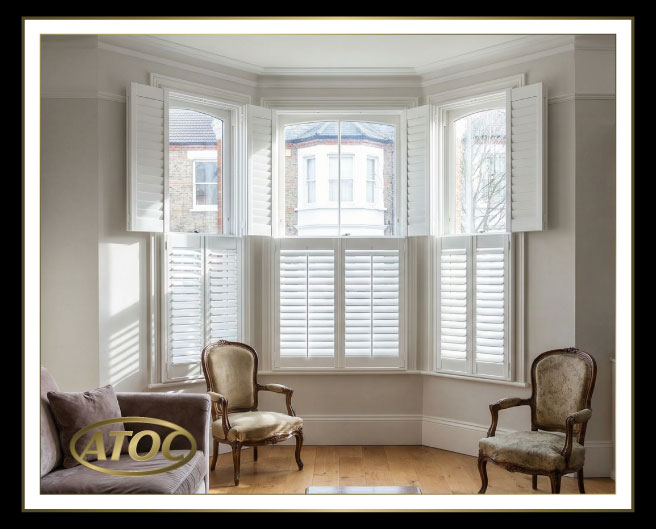 Tier-on-tier plantation shutters in an Essex bay window with the top tier open for daylight and the bottom tier closed for privacy