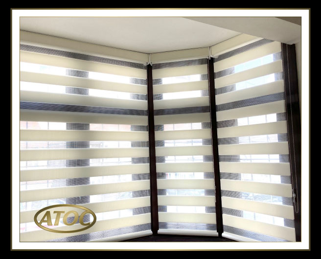 Day and Night Vision blinds with alternating sheer and opaque stripes in an Essex living room, keeping the view while controlling light