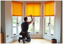 Professional installer fitting made-to-measure blinds